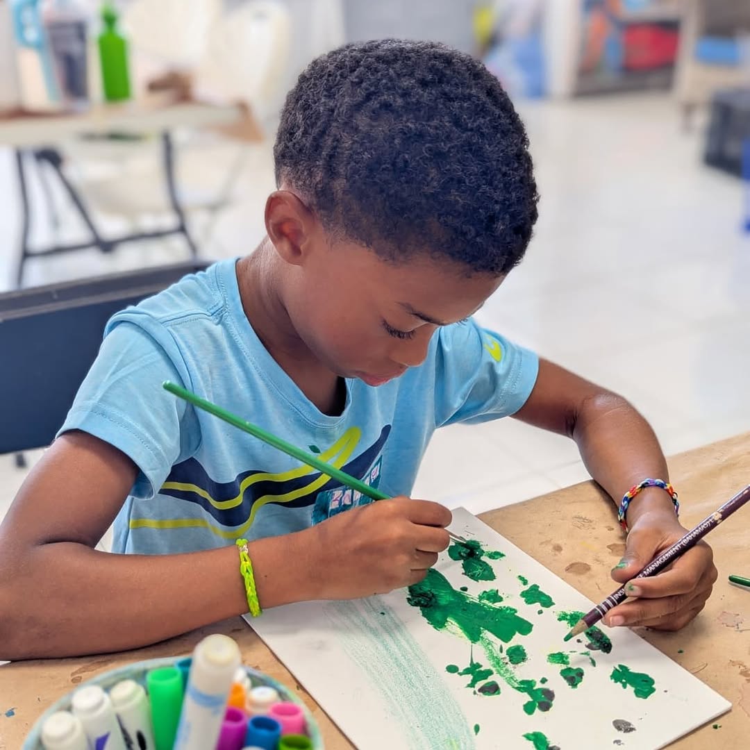 Exuma Arts Network Gallery: child engaging in art