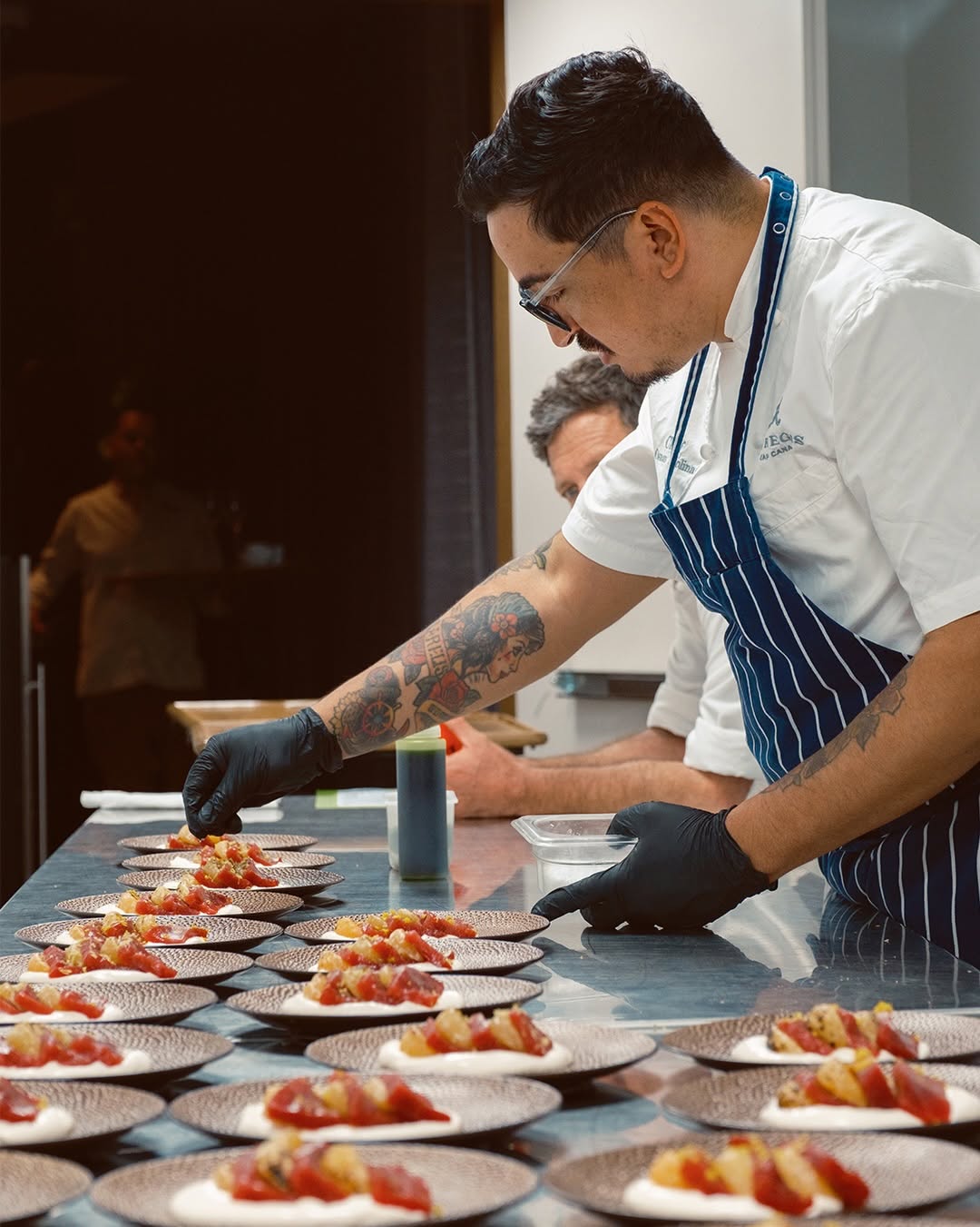 NINA Restaurant by Chef Diego Muñoz: professional photo of chef plating