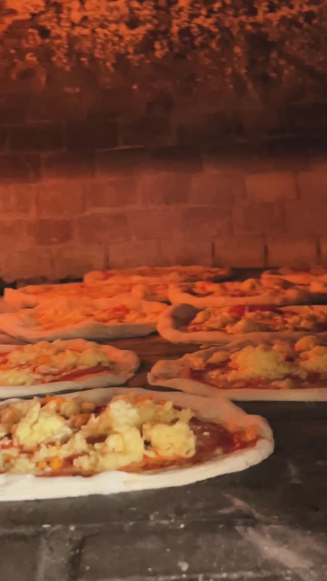 Ezzio's Pizza: appetizing photo of pizza baking