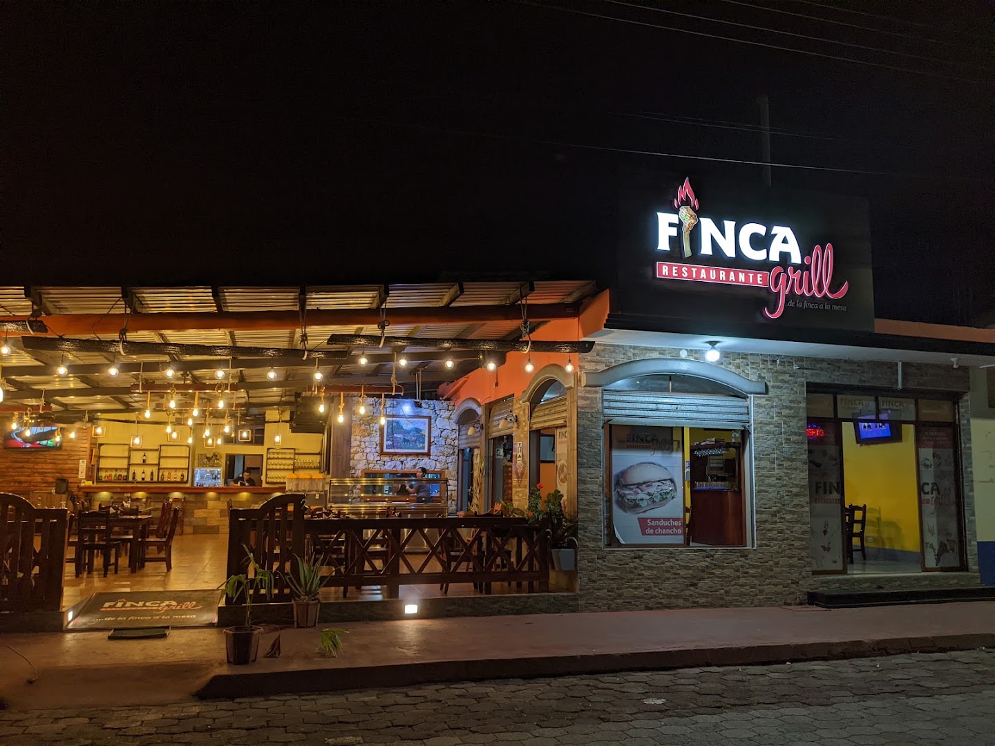 Finca Grill: clear, inviting exterior night shot