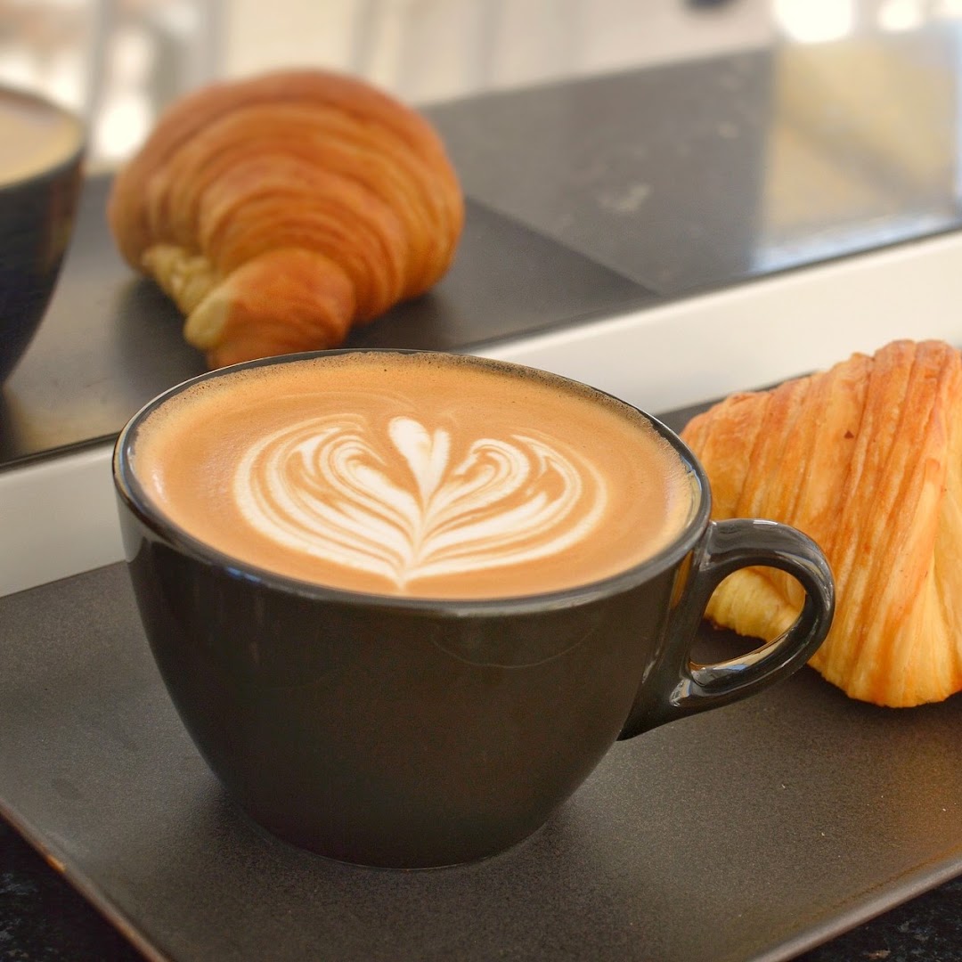Caravan Specialty Coffee: appetizing coffee and pastry photo