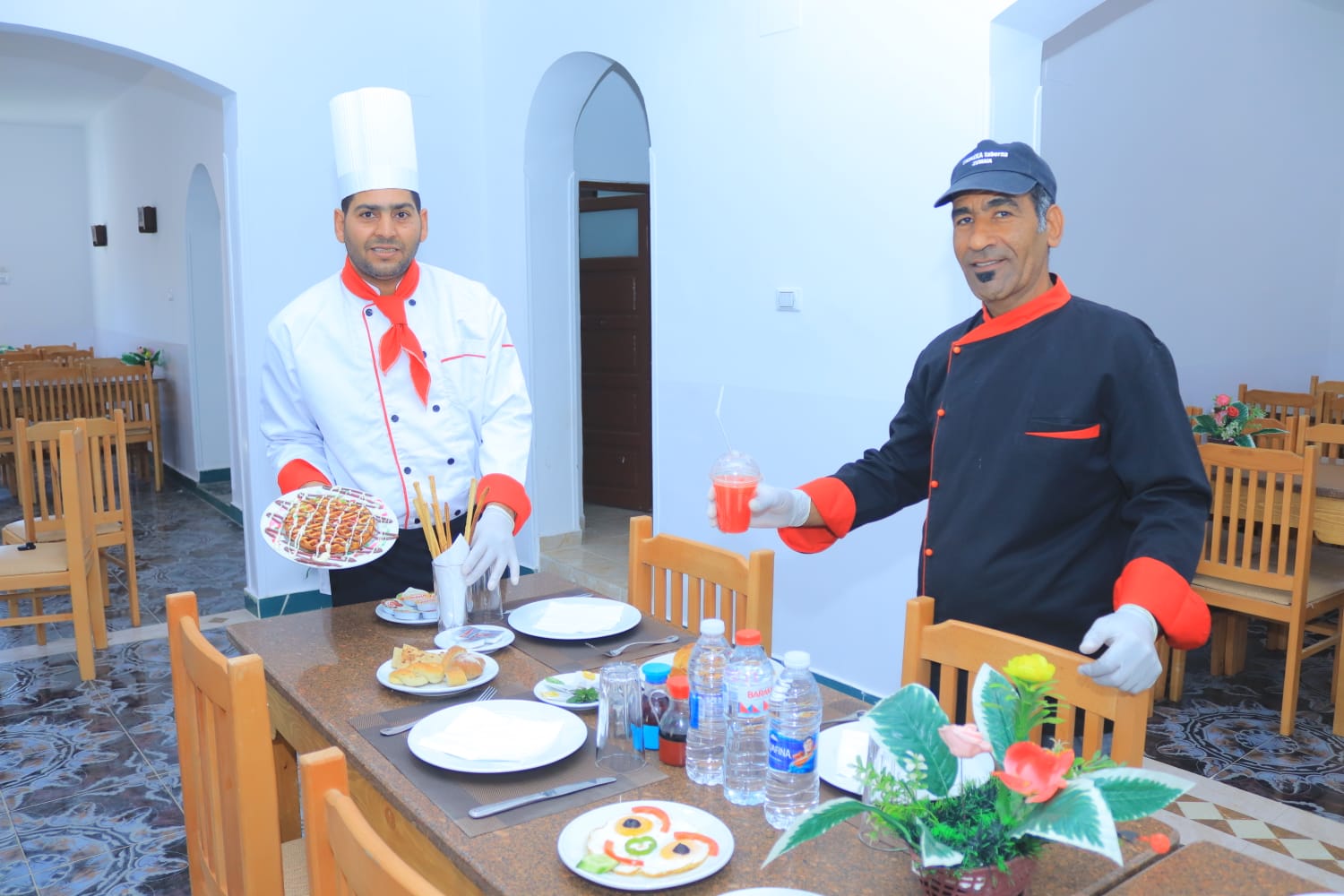 Ali Baba Restaurant: professional staff showcasing restaurant offerings