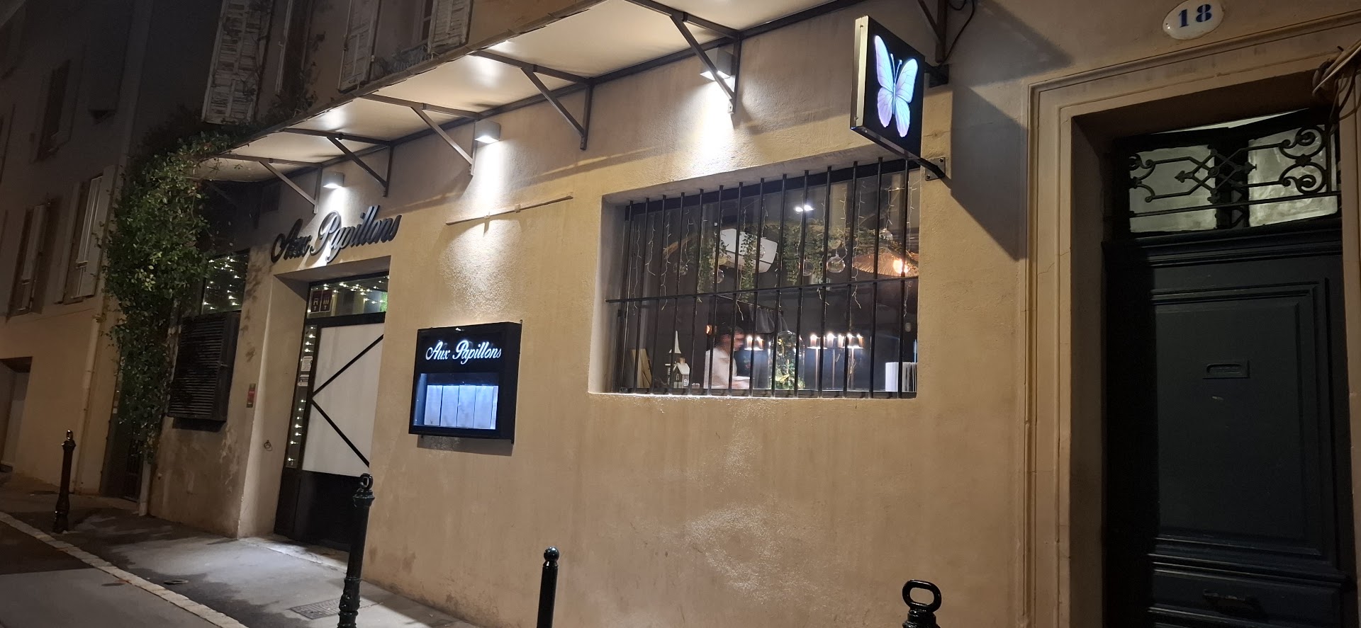 Aux Papillons: clear, inviting exterior night shot