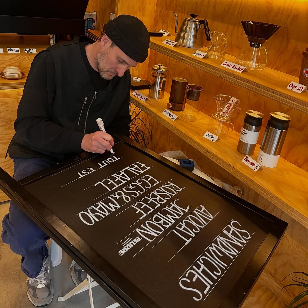 Édition Café: staff creating menu signage