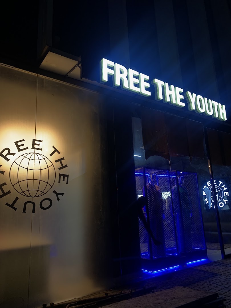 Free The Youth Flagship Store: clear, professional storefront night shot