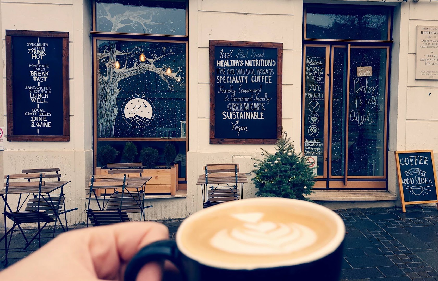 Lyr: inviting exterior shot with coffee