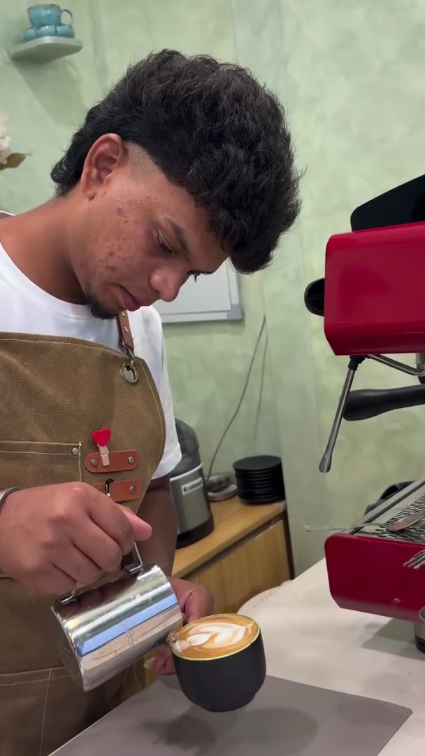 Cafe June: professional barista preparing latte art