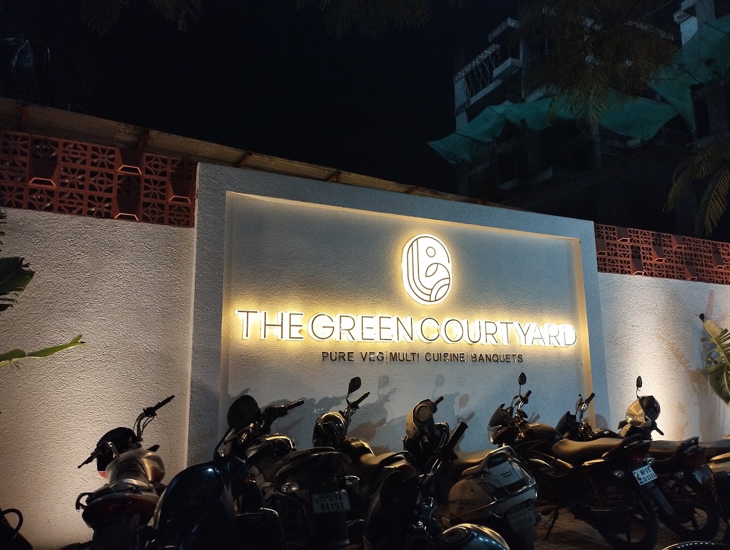The Green Courtyard: clear exterior signage at night