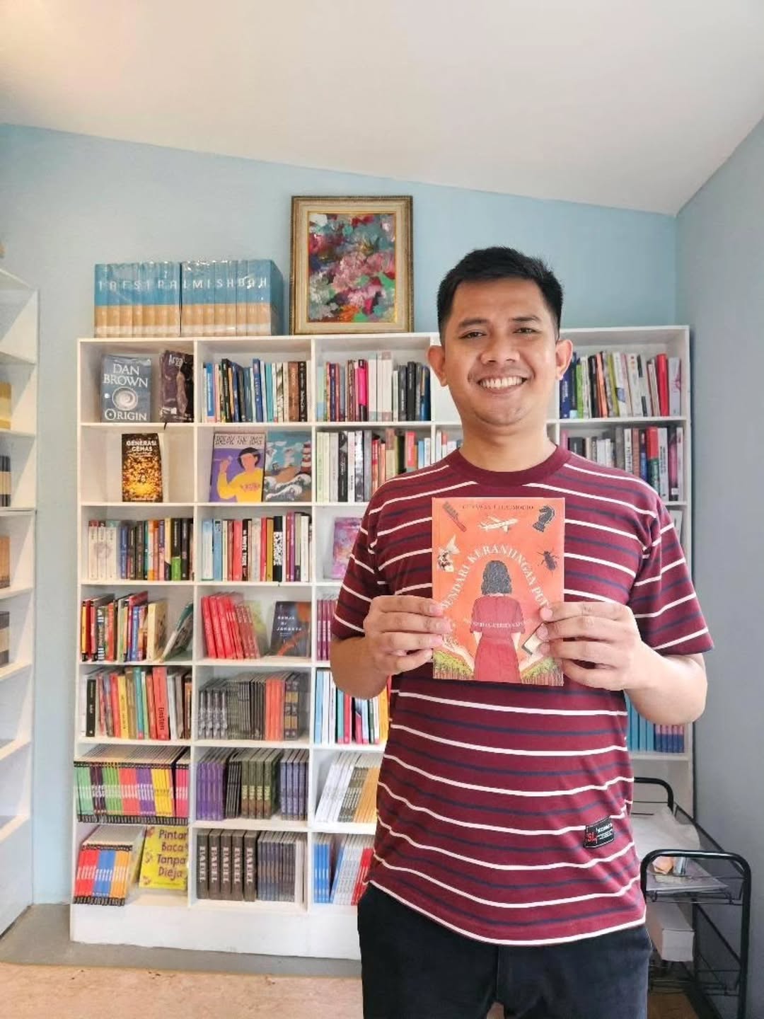 Akal Buku: friendly staff showcasing shop products