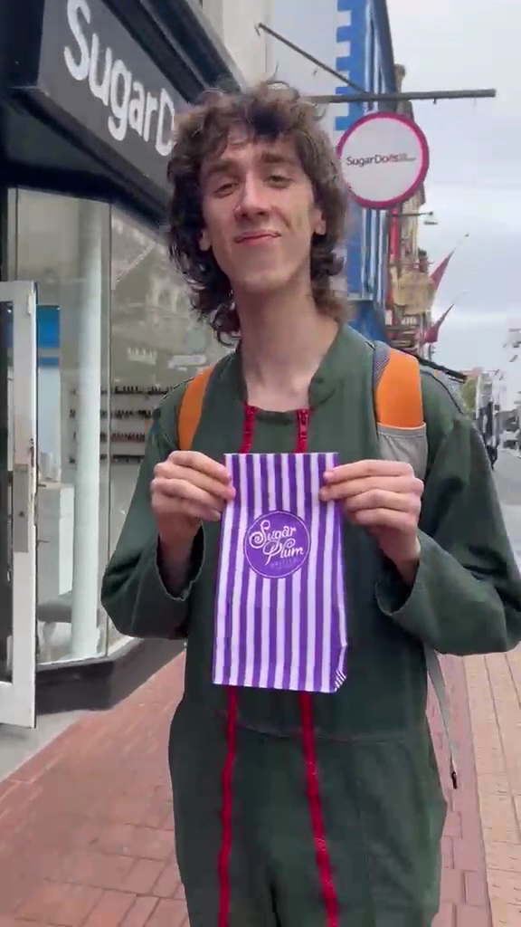 Sugar Plum Sweetery: customer showing shop product clearly