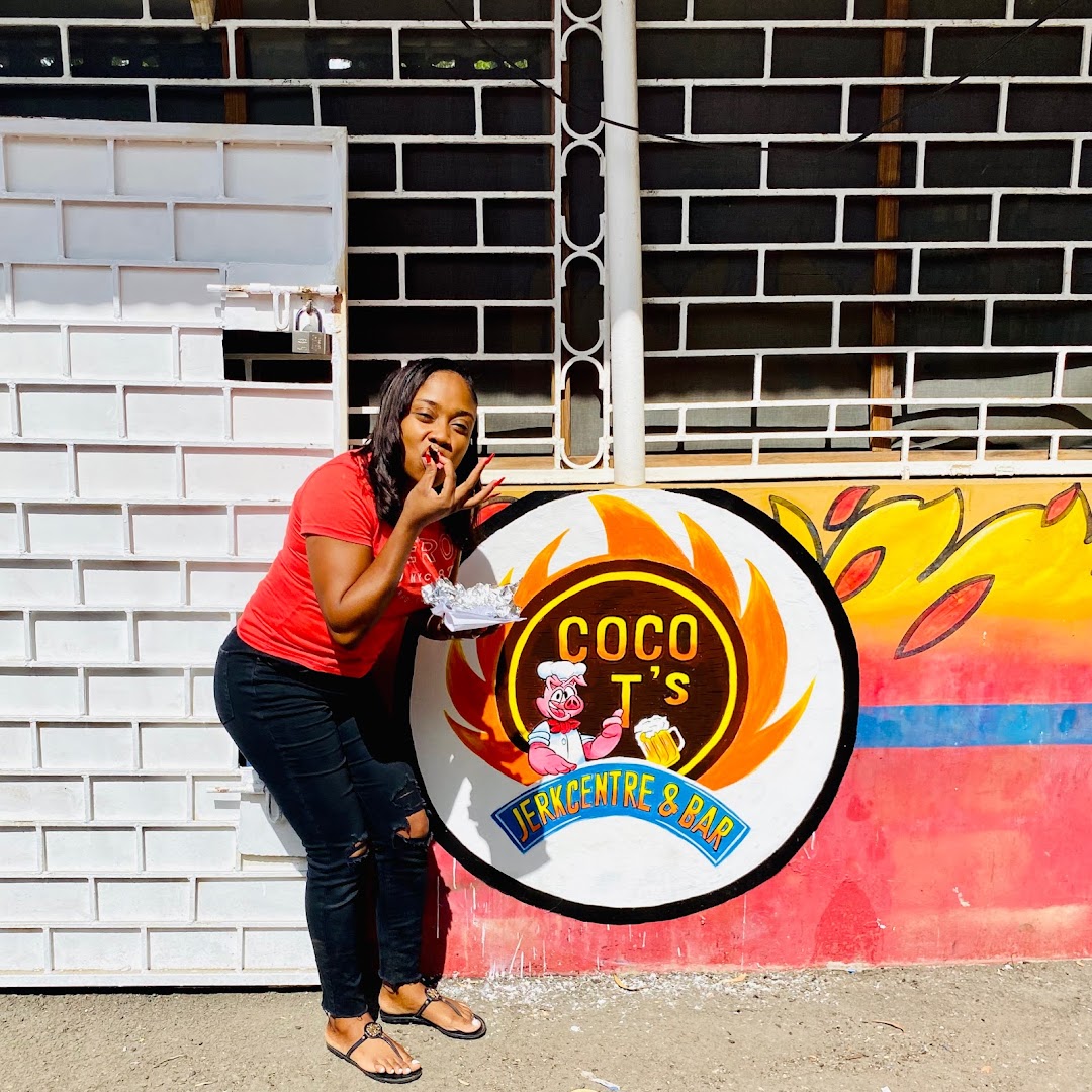 Coco T's Jerk Centre & Bar: customer enjoying food at venue