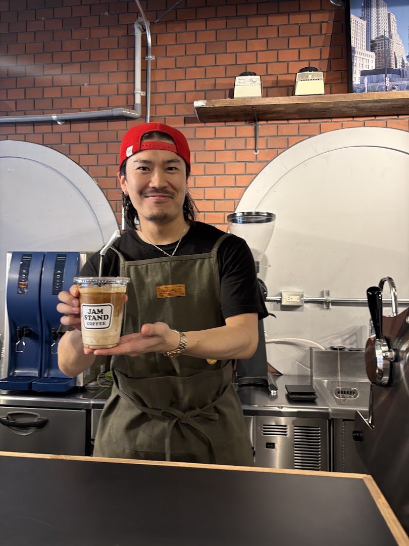 Jam Stand Coffee Shinsaibashi: friendly staff member with coffee