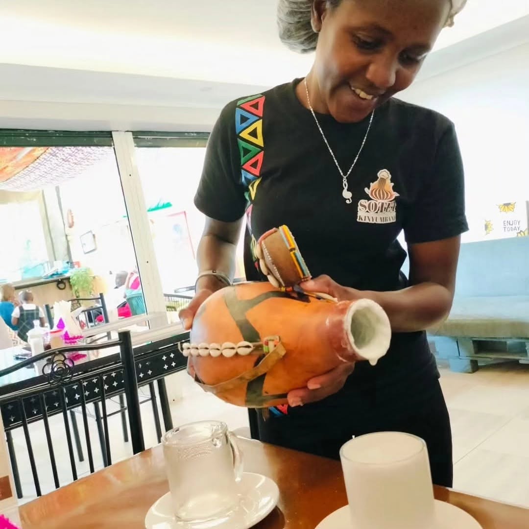 Sotet Kinyumbani: professional staff serving traditional drink