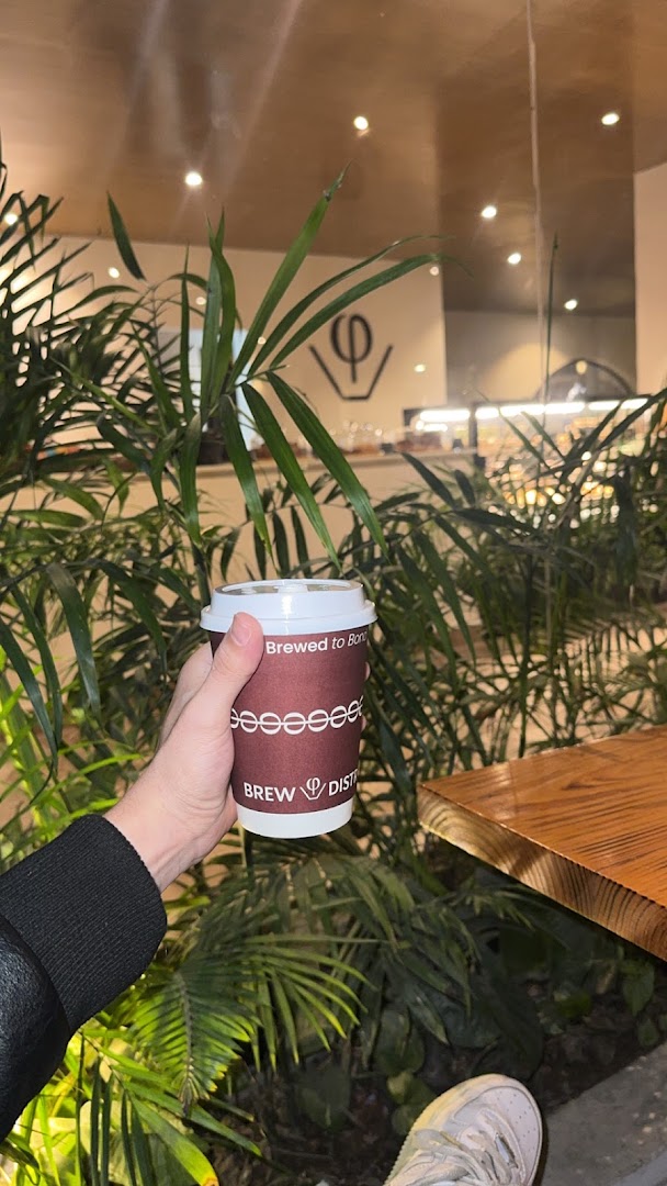 Brew District Cafe: inviting atmosphere with branded cup