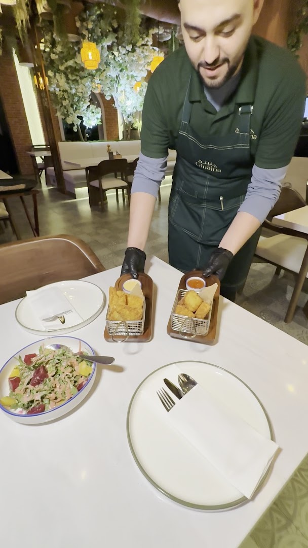 Ginaina Gourmet: professional staff serving appetizing food