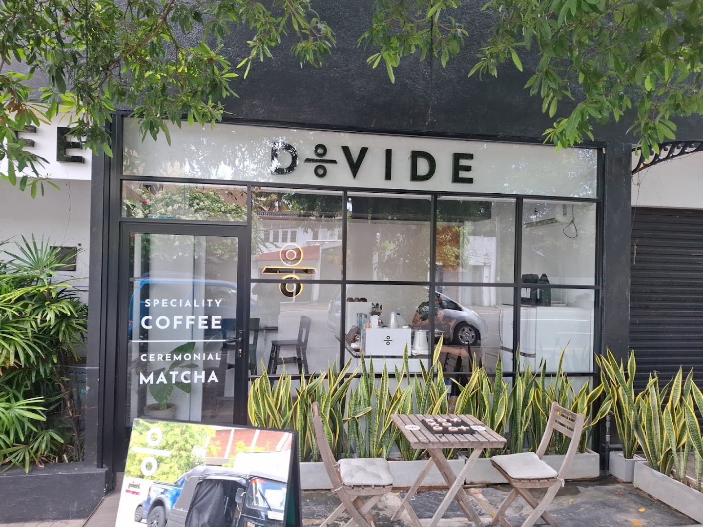 Divide: clear storefront photo of venue