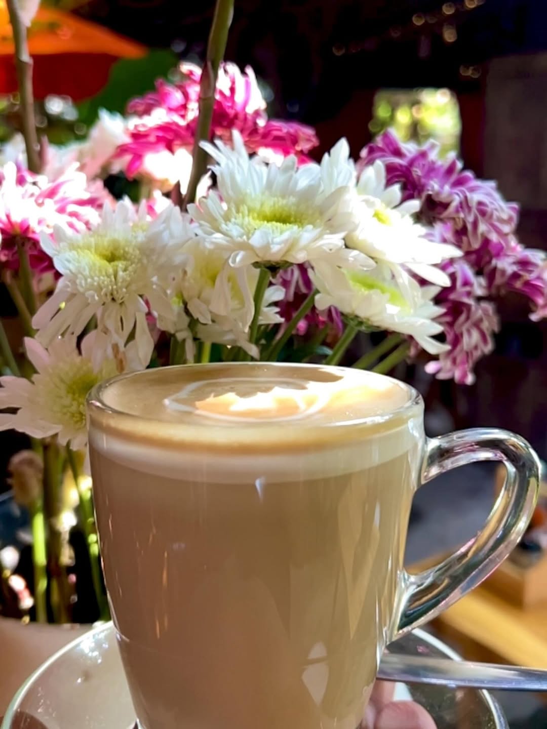 Om Garden Café: appealing photo of coffee and flowers