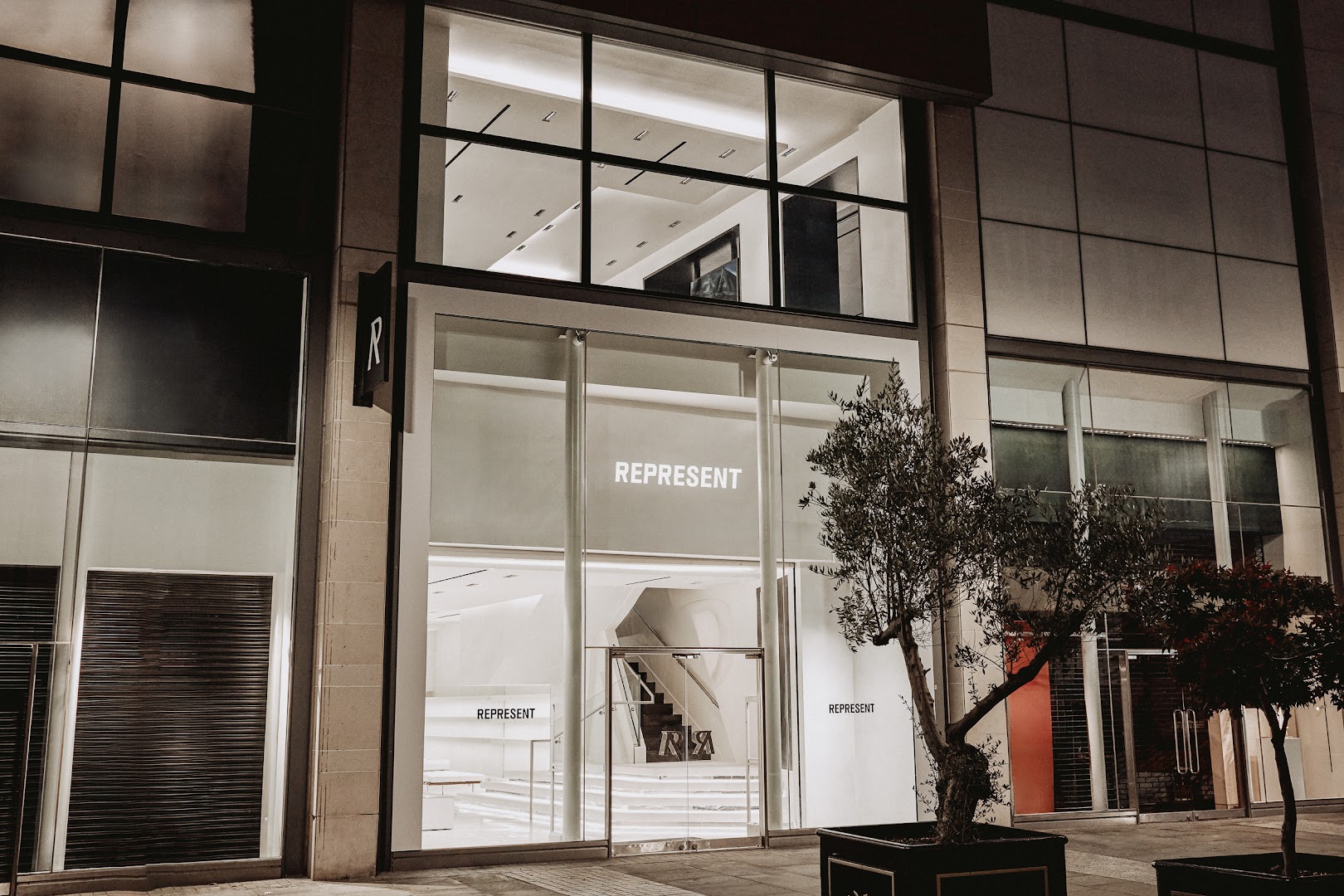 Represent Manchester: professional storefront photo at night