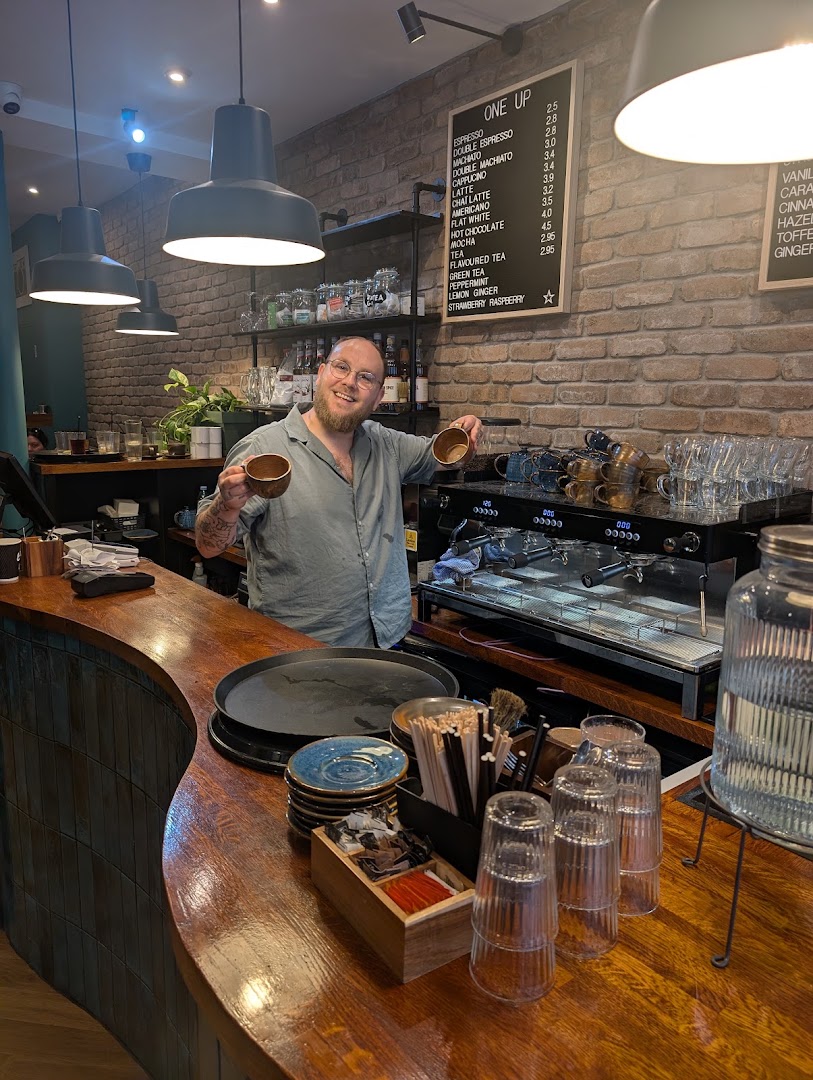 One Up: friendly staff in venue setting