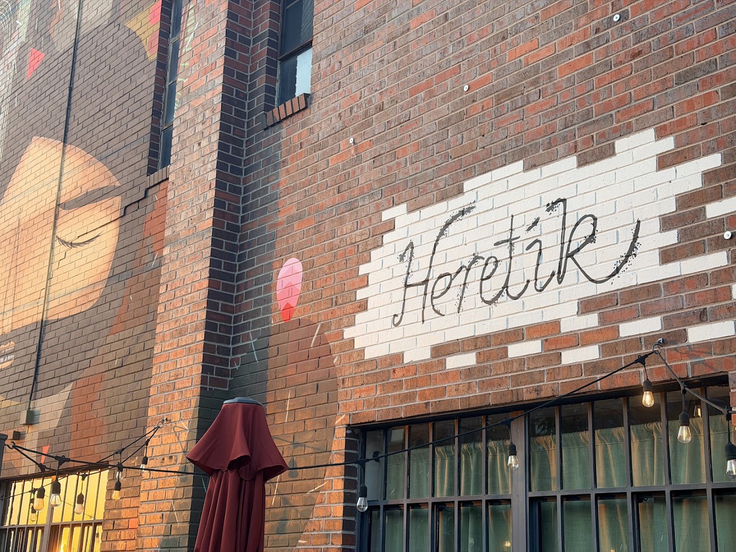 Heretík: clear exterior shot showing branding