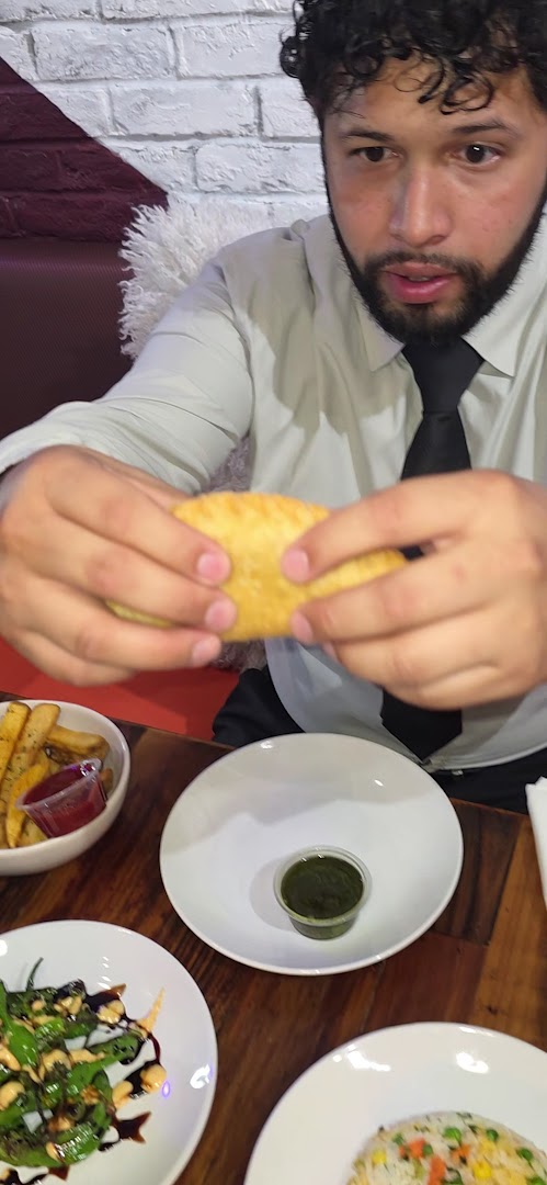 Loaded Empanadas: clear photo of food and customer