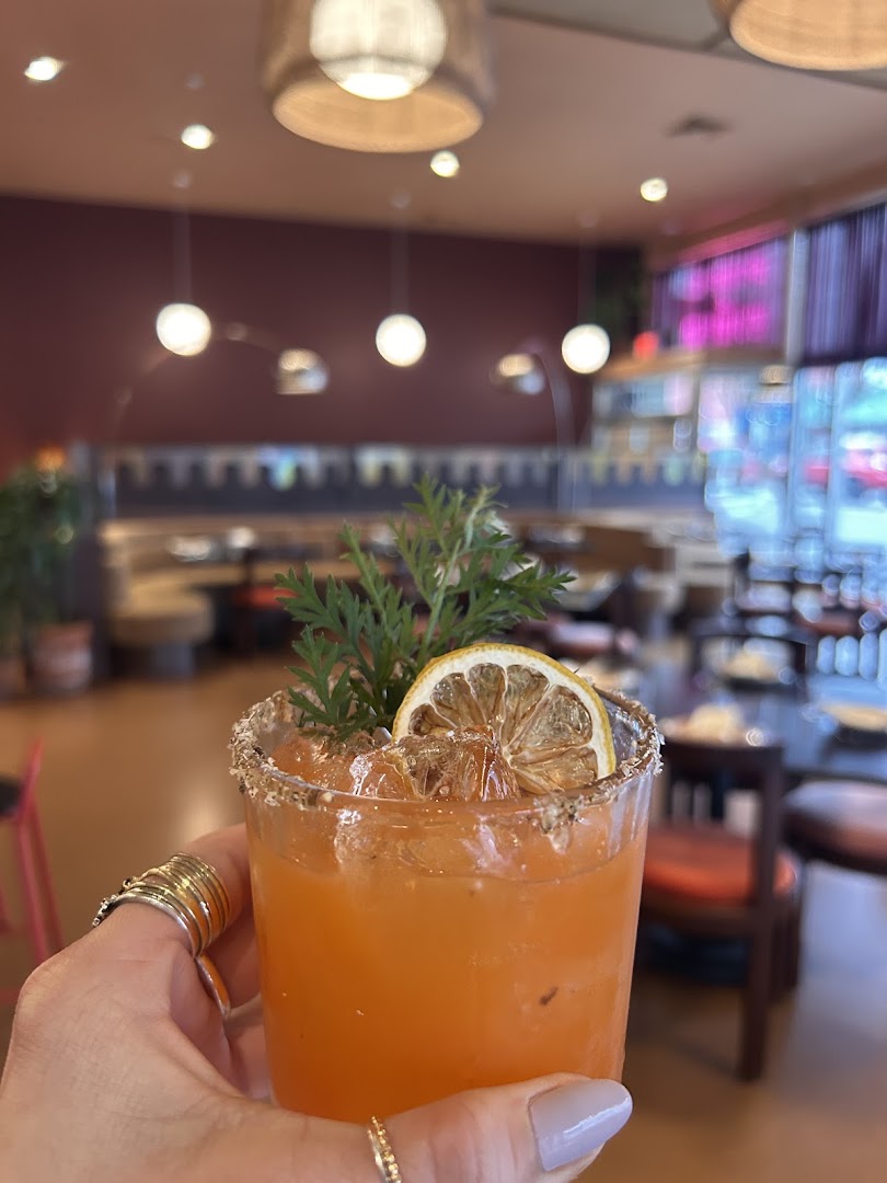 Adelleda: appealing cocktail with restaurant background