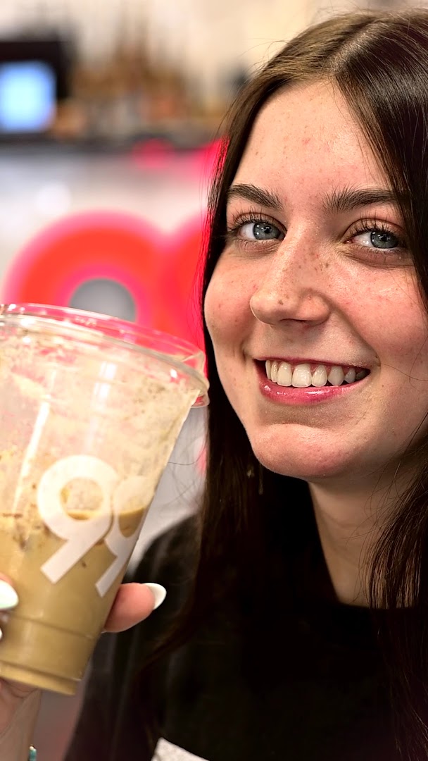 99 Cafe: customer enjoying branded cafe drink