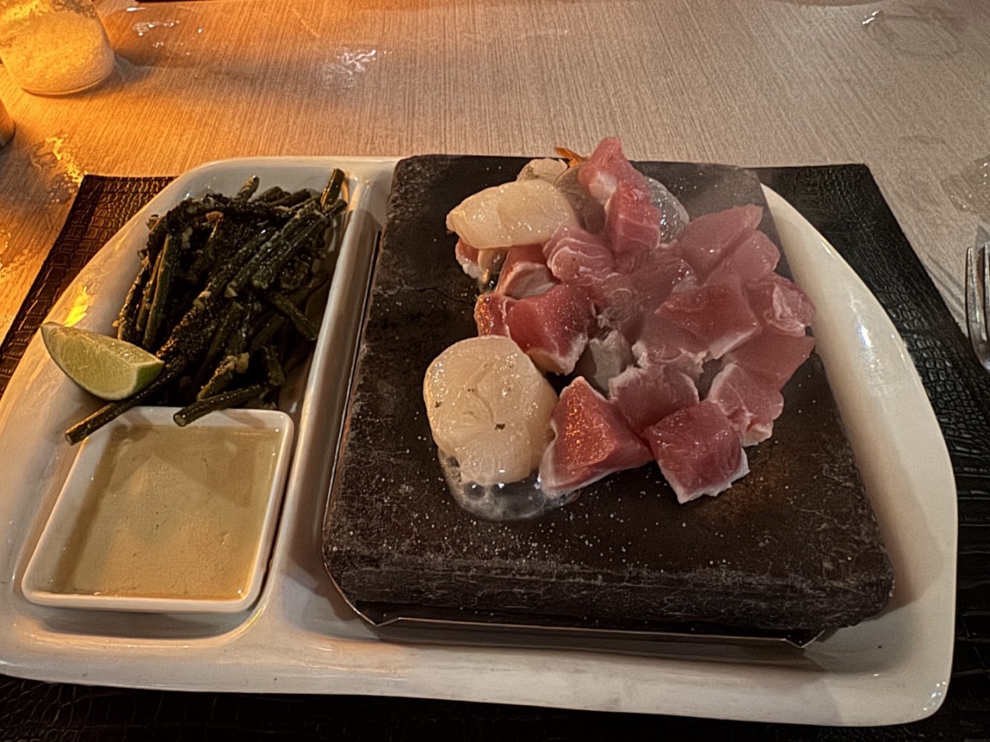 The Stonegrill Restaurant: appetizing food presentation on hot stone