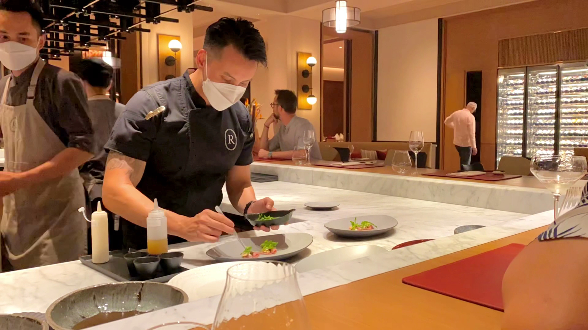 Oku: professional shot of chef plating